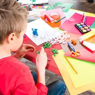 A child making paper crafts at a table